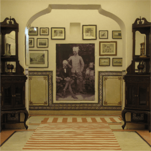 Eka_resources-ARCHIVING_Legacy Framed historic photographs in a sepia-toned room
