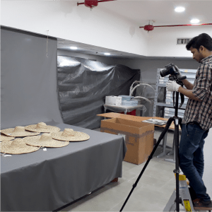 Eka_resources-Curation-2 A photographer shooting wide-brimmed hats in a studio